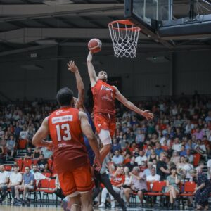 Leicester Riders Basketball Player Dunking the Ball